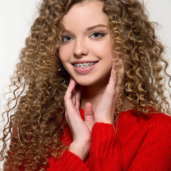 Teenage girl smiling with braces.